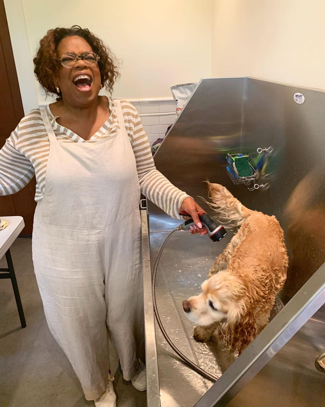 Oprah Winfrey bathing her dog Sadie
